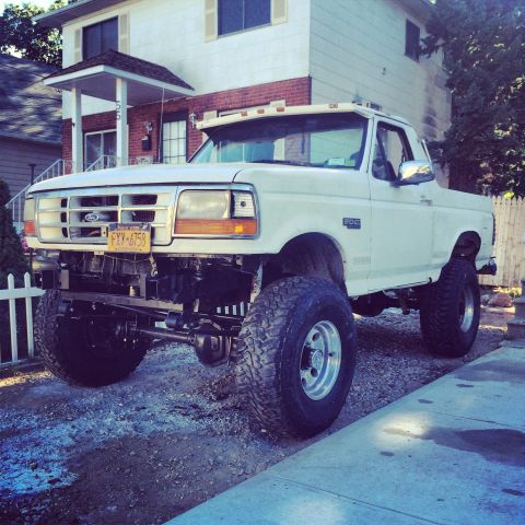 1994 Ford Bronco - This lifted Ford Bronco features a modified suspension and large off-road tires.
