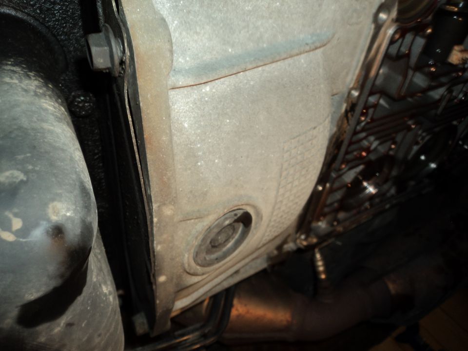 Underside view of vehicle transmission and exhaust pipe