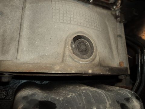 2004 Mercury Grand Marquis - This is a close-up view of a metal engine component, likely part of the transmission or oil pan.