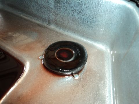 2004 Mercury Grand Marquis - Transmission pan showing the drain plug and fluid, indicating a potential maintenance check.
