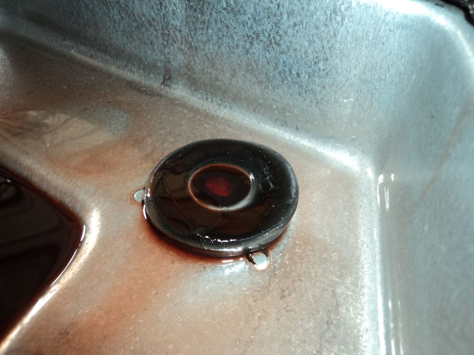 Transmission pan with drain plug and reddish fluid