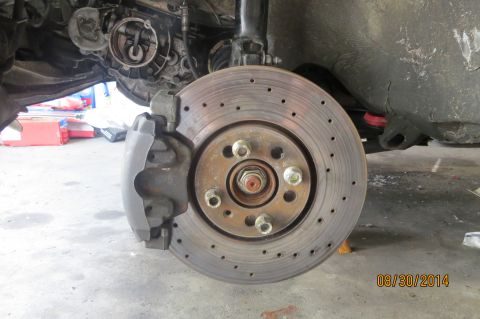 1985 Volkswagen GTI - Close-up view of a vehicle's front brake rotor and caliper, showing mechanical components.