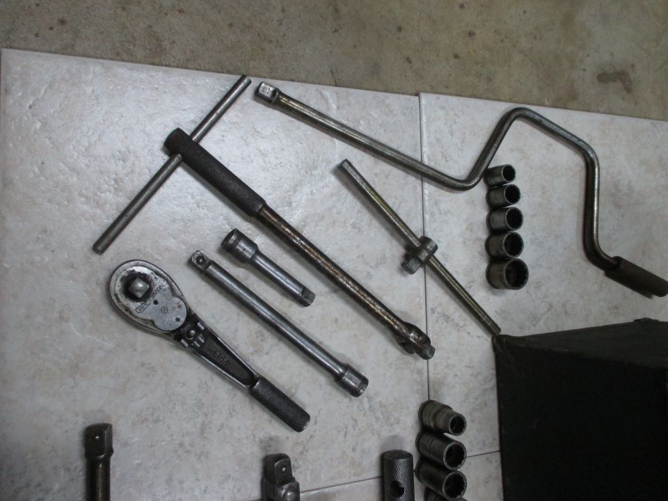 Socket wrench set with T-handle, ratchet, and various sockets