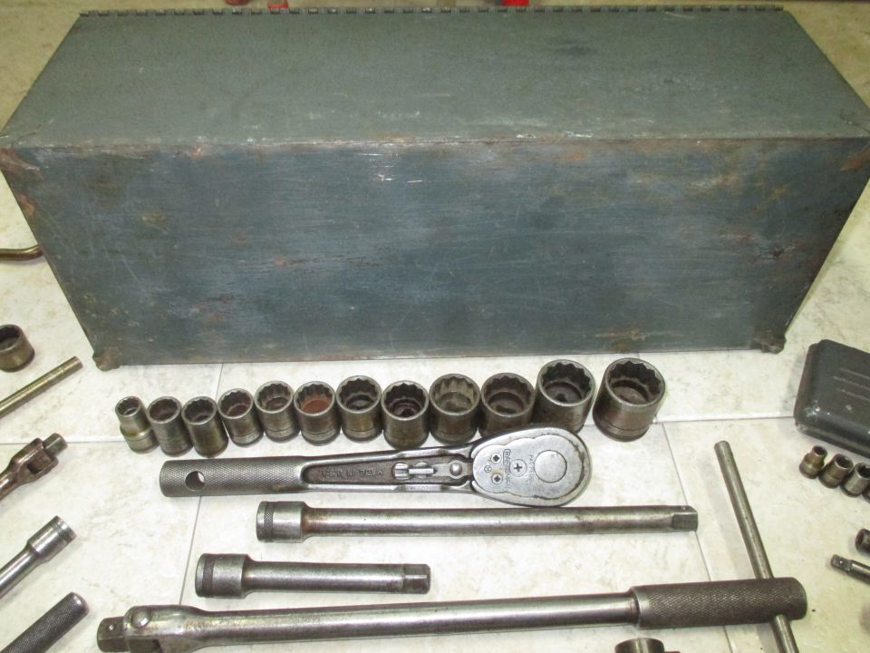 Gray metal tool chest with assorted sockets and ratchets