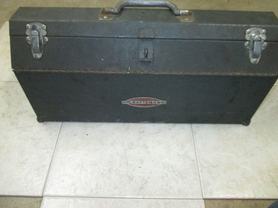 Gray metal toolbox with a handle and latches, showing a red and silver Craftsman logo