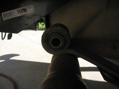 1994 Ford Bronco - Close-up of a leaf spring bushing, with a part number sticker visible on the frame.