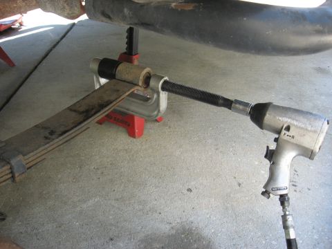1994 Ford Bronco - Removing a leaf spring bushing using a C-clamp tool and an impact wrench.