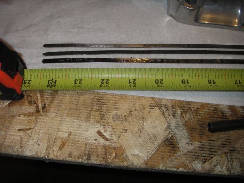 1972 Ford Ranchero - Three engine dipsticks are shown laid out next to a measuring tape, with some text visible on the dipsticks.