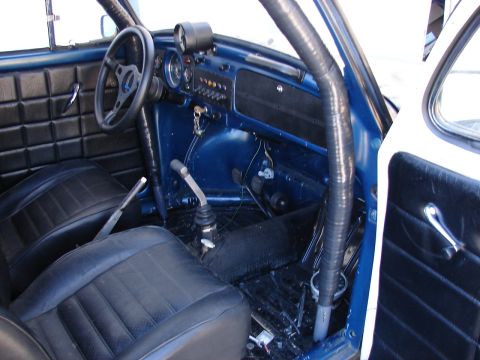 1964 Volkswagen Beetle - The interior of a modified Volkswagen Beetle features a roll cage and racing-style seats.