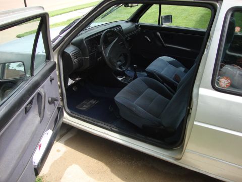 1985 Volkswagen GTI - Interior view of a 1985 Volkswagen GTI, highlighting the blue cloth seats and dashboard.
