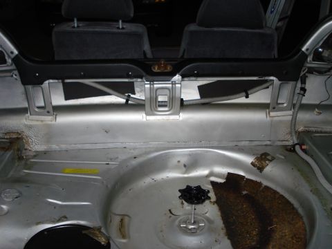 1985 Volkswagen GTI - The interior of a car trunk is shown, revealing the spare tire well and the back of the rear seats.