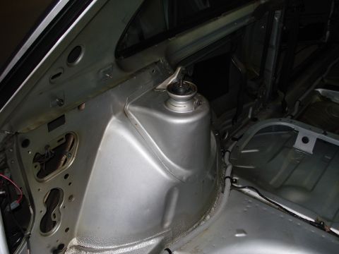 1985 Volkswagen GTI - The rear strut tower area of a car's interior is shown, with exposed metal and wiring.