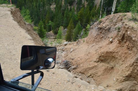 1983 Ford Bronco - Navigating a challenging off-road trail with a significant landslide blocking the path.