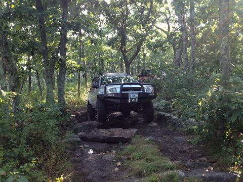 2003 Nissan Frontier - Silver 2003 Nissan Frontier tackles a challenging rocky path off-road.