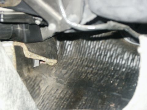 1998 Mercury Sable - Close-up view of the passenger side floor mat and surrounding interior components of a vehicle.