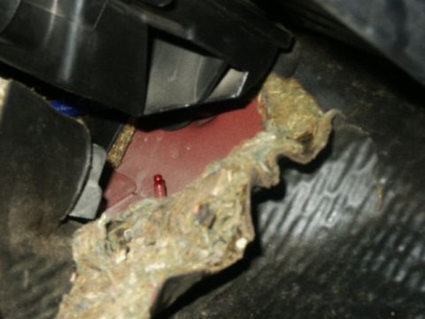 1998 Mercury Sable - A view of the vehicle's interior reveals exposed wiring and insulation near a red painted metal component.
