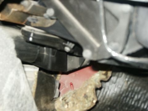 1998 Mercury Sable - Close-up view of vehicle undercarriage components, showing various metal and plastic parts.