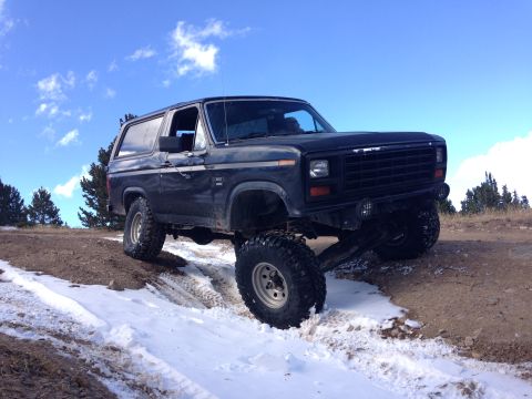 1983 Ford Bronco - This 1983 Ford Bronco navigates a snowy, off-road trail with its large tires.