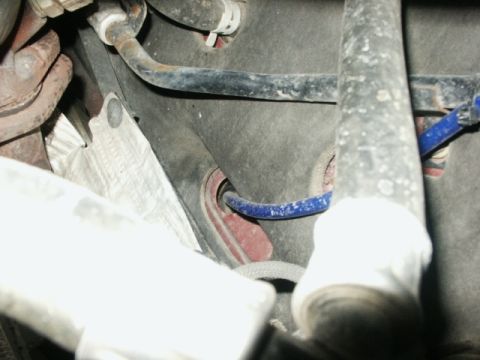 1998 Mercury Sable - Close-up view of various hoses and metal parts within a vehicle's engine bay.