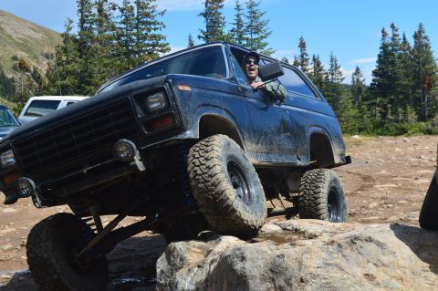 1983 Ford Bronco - This 1980s Ford Bronco navigates a challenging rocky trail with a driver enjoying the ride.