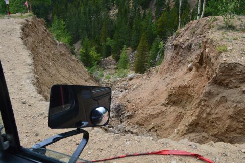 1983 Ford Bronco - Navigating a challenging off-road trail with a significant landslide blocking the path.
