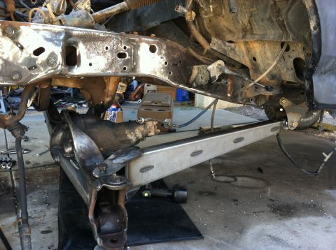 1995 Ford Bronco - Close-up view of a vehicle's undercarriage, showing the frame and suspension system during a repair or modification.