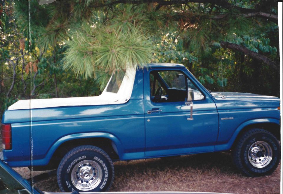 Blue 1982 Ford Bronco side view with white removable top