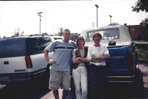 1982 Ford Bronco - A group poses for a photo with two vehicles in the background.