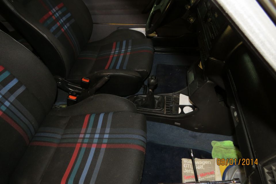 1985 Volkswagen GTI interior with plaid seats and manual shifter