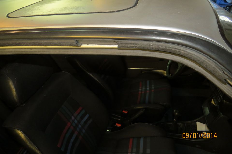 Interior of a 1985 Volkswagen GTI showing plaid seats and sunroof