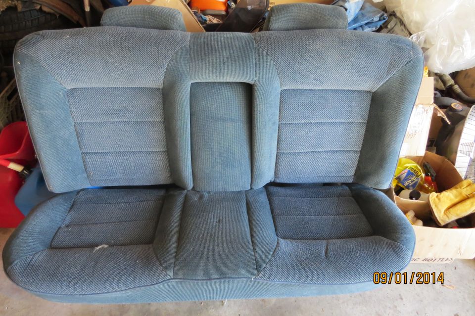 Blue fabric car rear seat with headrests and folding armrest