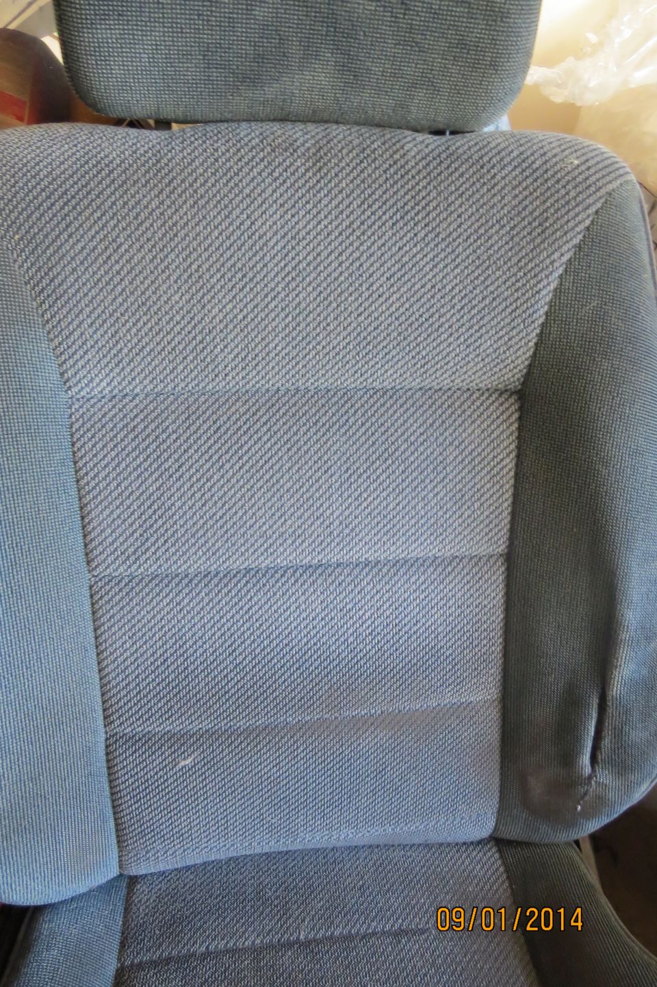 close-up of gray fabric car seat with horizontal stitching pattern