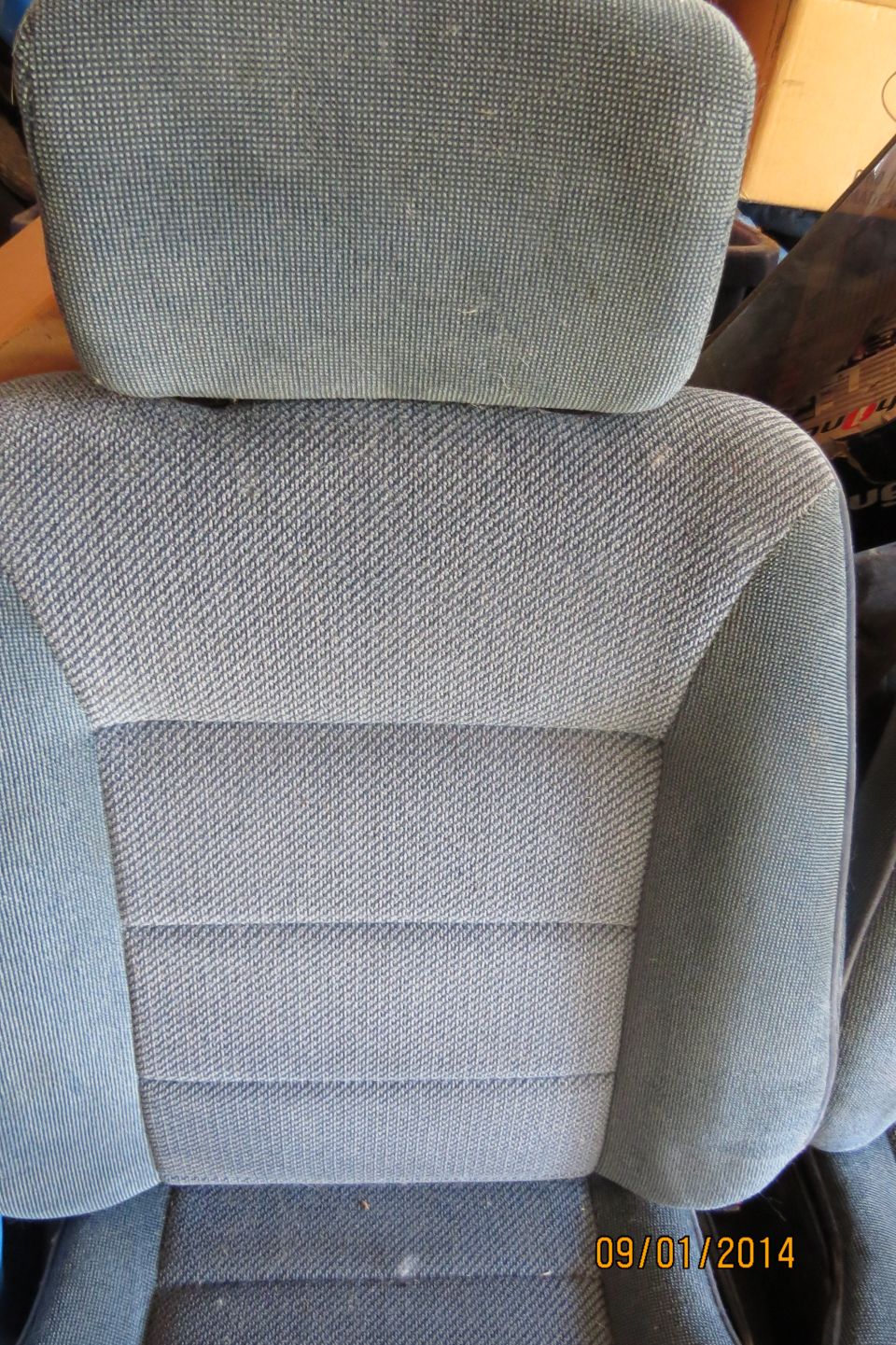 Close-up of grey fabric car seat with horizontal stitching detail and headrest