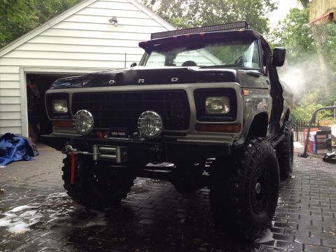 1979 Ford Bronco - This lifted Ford truck, likely from the late 1970s, is being washed in a driveway.