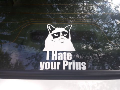 2000 Mercury Grand Marquis - A sticker on a car's rear window displays a grumpy cat and text that reads "I Hate your Prius."