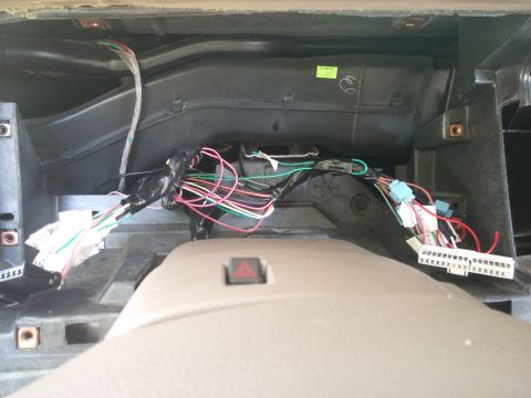 2000 Mercury Grand Marquis - The exposed wiring harness inside the dashboard of a vehicle shows a complex network of connections.