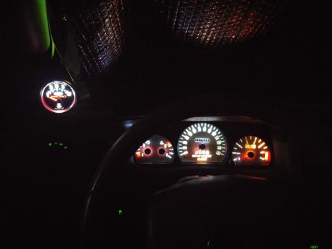 2000 Mercury Grand Marquis - The illuminated dashboard gauges and tachometer of a 2000 Mercury Grand Marquis are visible in this interior shot.