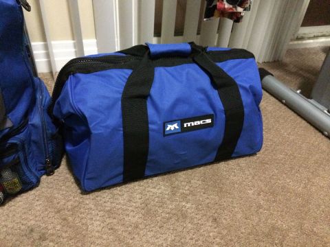1997 Dodge 3500 - A blue duffel bag with a Macs logo is placed on a carpeted floor.