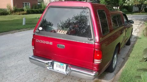 2006 Ford E350 - Rear view of a red Dodge pickup truck equipped with a Leer cap. The license plate is visible.