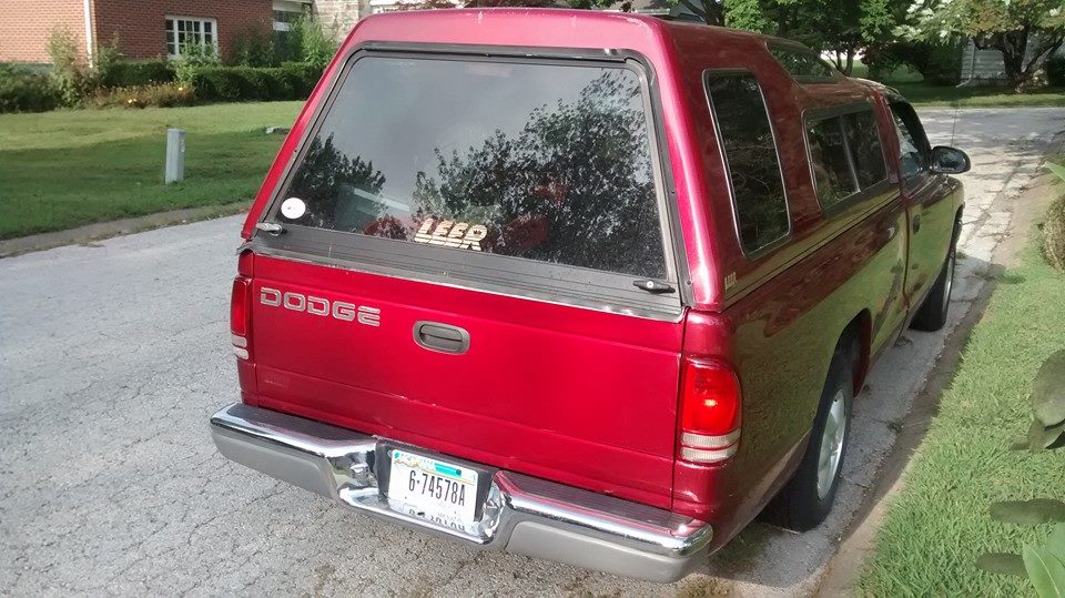 Red Dodge pickup truck rear view with Leer cap and license plate 6-74578A