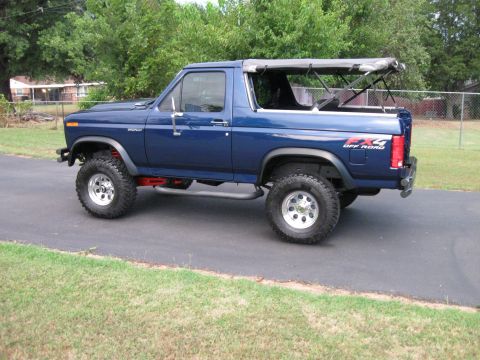 1982 Ford Bronco - This blue Ford Bronco features an FX4 Off Road decal on the rear fender and a removable soft top.