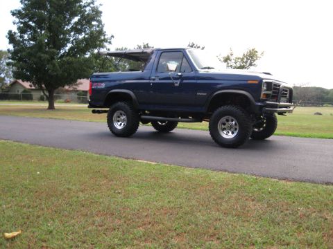 1982 Ford Bronco - This lifted 1982 Ford Bronco is shown from a three-quarter front view on a paved road.