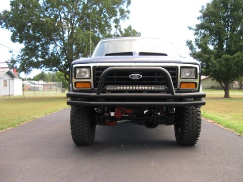 1982 Ford Bronco - This Ford Bronco features a prominent grille guard and a light bar mounted on the front bumper.