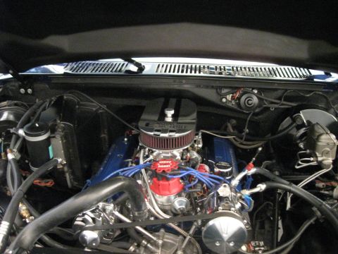 1982 Ford Bronco - Close-up view of a modified V8 engine, blue valve covers and a prominent air filter assembly.