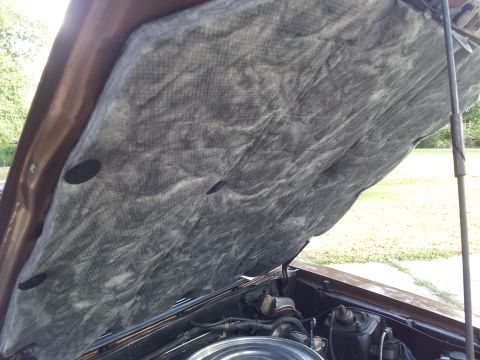 1980 Ford Mustang - Close-up of a car's hood insulation with visible engine parts and a website logo.