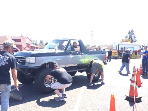 1989 Ford Bronco - A lifted 1992 Ford F-150 pickup truck is being measured by participants at an off-road show.