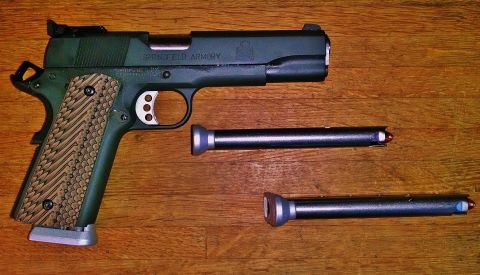 1996 Ford Bronco - Springfield Armory 1911 pistol disassembled with two magazines, one loaded with a red-tipped round.
