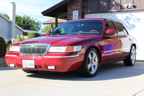 2002 Mercury Grand Marquis - Red 2002 Mercury Grand Marquis with custom wheels and personalized license plate.