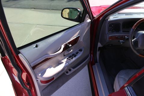 2002 Mercury Grand Marquis - Interior view of a 2002 Mercury Grand Marquis, focusing on the driver's side door and dashboard.