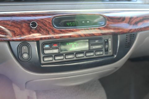 2002 Mercury Grand Marquis - Interior view of a car's dashboard, climate controls and a digital clock.
